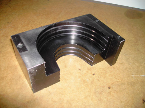 Metal component with curved groove.
