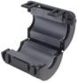 Black ferrite clamp with grooved sides and curved shape.