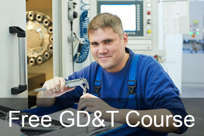 Man in blue overalls holding tool with measuring device at a workshop desk.
