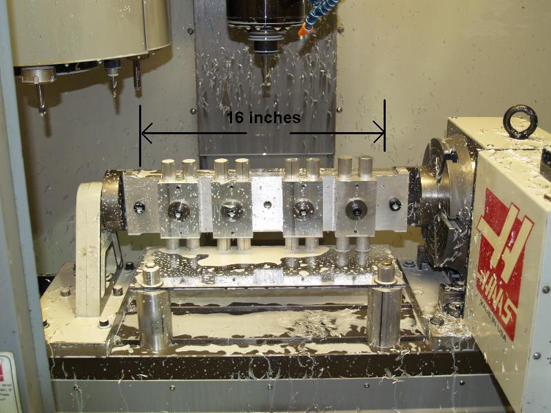 A CNC milling machine setup with 4-axis configuration and tools.
