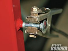 Industrial tool with Street Rodder text, red lever, and dark gray handle, in a workshop setting.