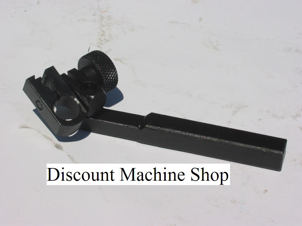 Black metal tool with long handle and adjustable knob against a white background.