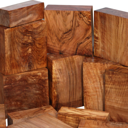 Wooden blocks with dark brown color and visible grain patterns on a white background.