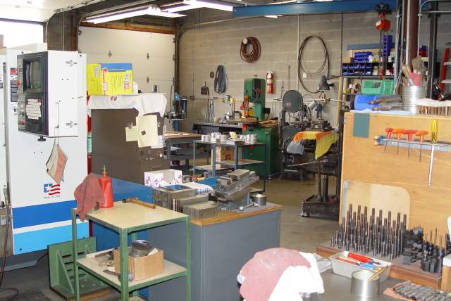 Well-equipped machine shop with lathes, milling machines, and grinders.