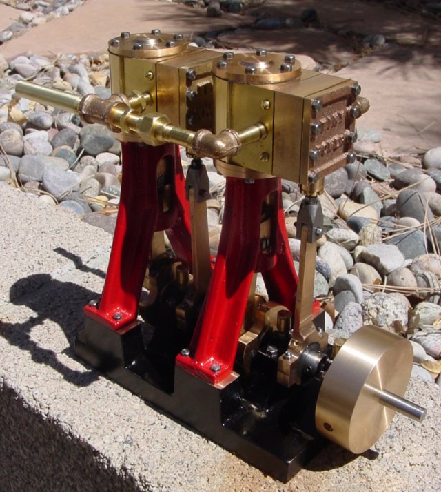 Intricately designed mechanical device with red base.