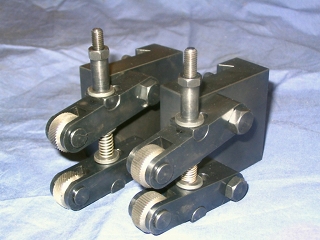 Black metal knurling holder with textured surface and threaded rods.