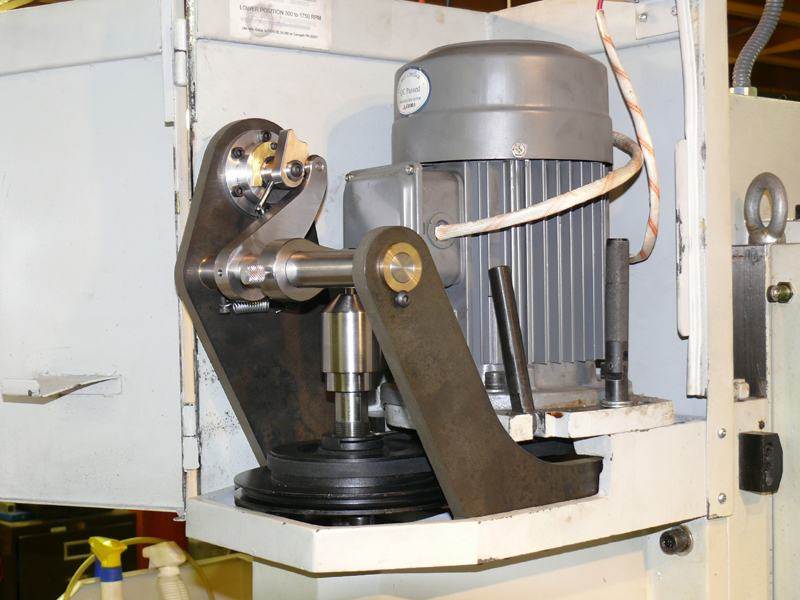 Industrial machine with motor, gears, and control panel.