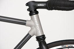 Magnesium carbon bicycle frame with light gray color and black accents.
