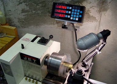 Compact lathe with digital readout displaying 100-108 in red.