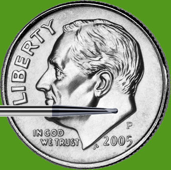 A close-up image of a dime with a tool measuring its edge.