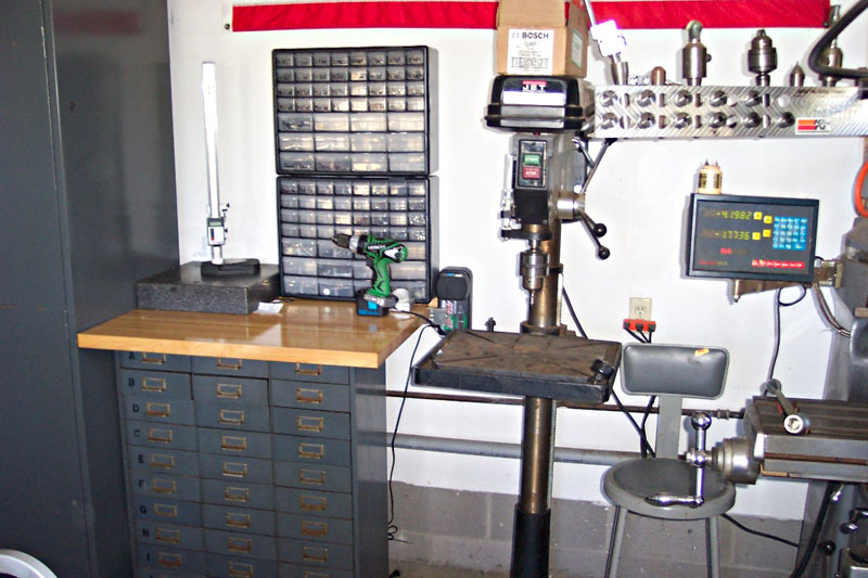 A well-organized workshop with machinery, tools, and cabinets.