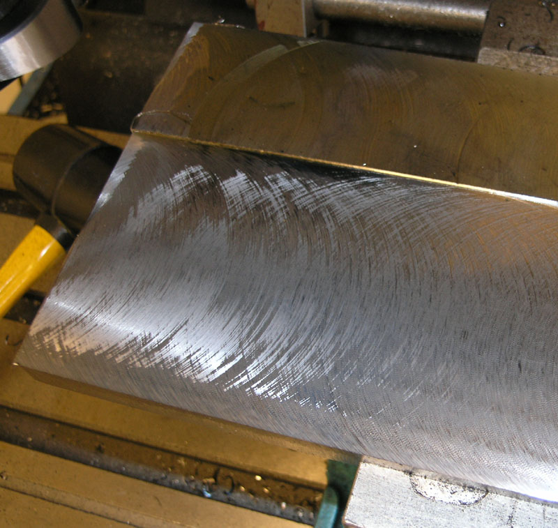 Close-up photograph of scratched metal surface.