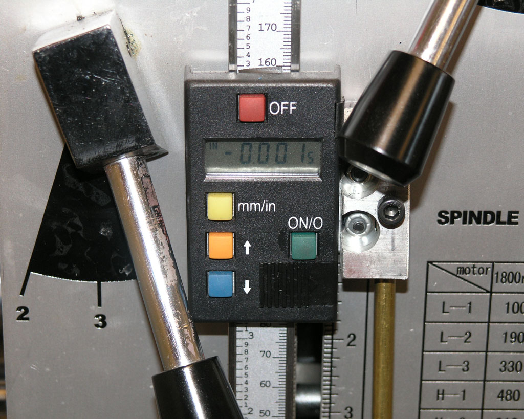 Digital readout device attached to a milling machine or lathe spindle.