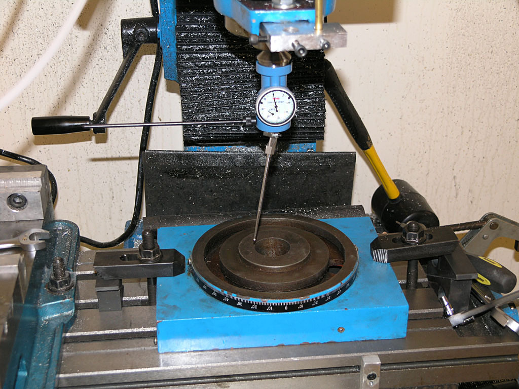 Blue and black metalworking tool with dial gauge.