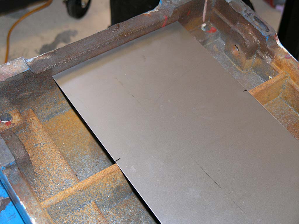 A piece of metal being cut by a cutting tool on a workshop or factory floor.