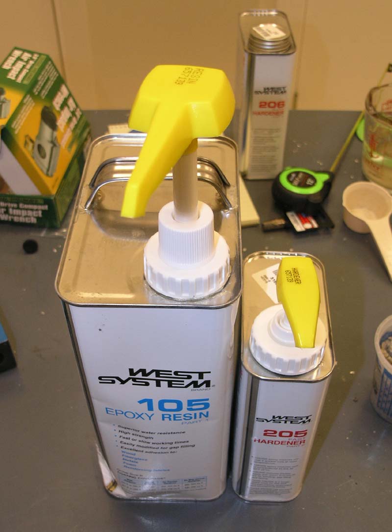 Machining equipment, tools, and materials on a workbench.