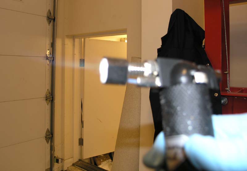 A garage door with an open center, showing its metal frame and panels.