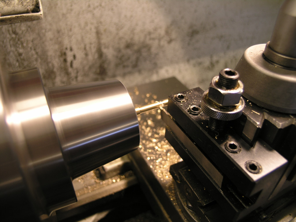 Metalworking lathe with close-up view of tool holder and chuck.