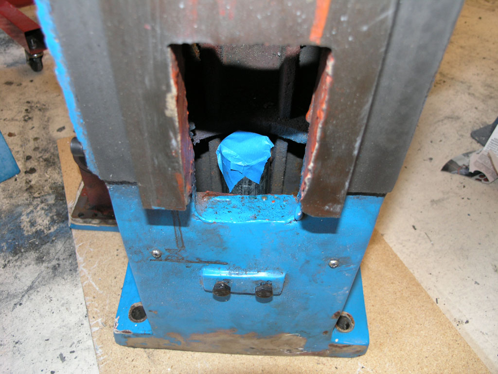 Heavy-duty metal press or vice.