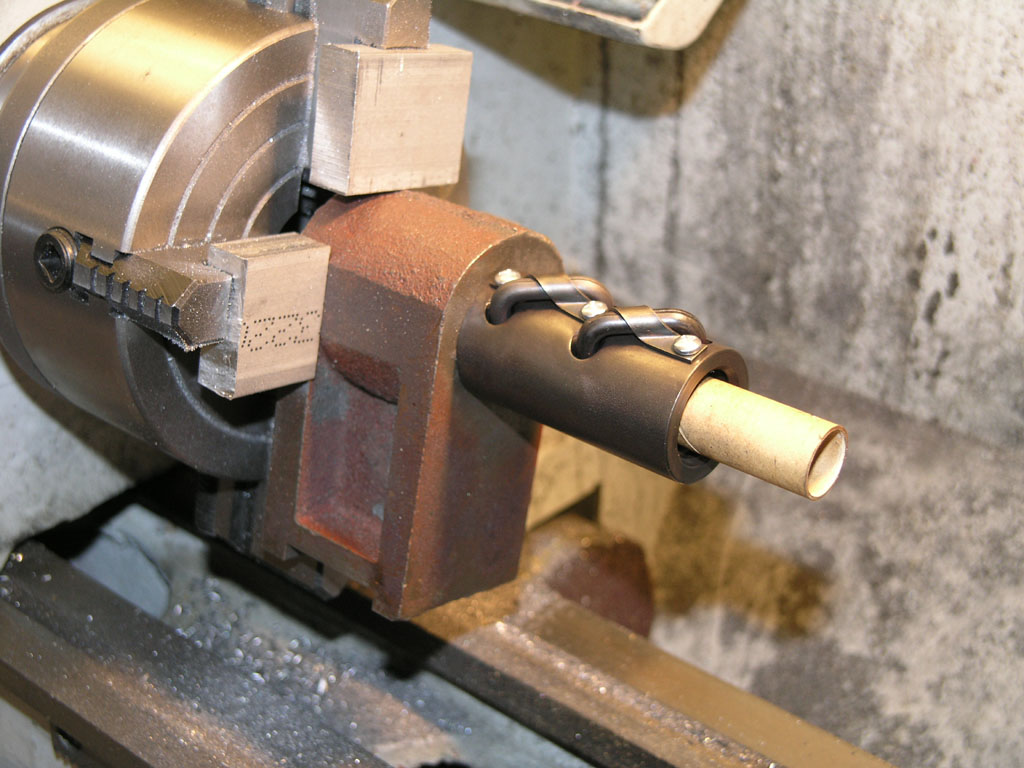 Metal lathe tailstock with cylindrical piece and central hole.