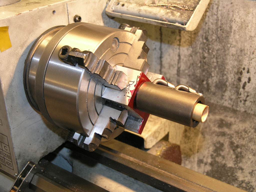 A metalworking tool with a cylindrical shape and central hole on a machine.