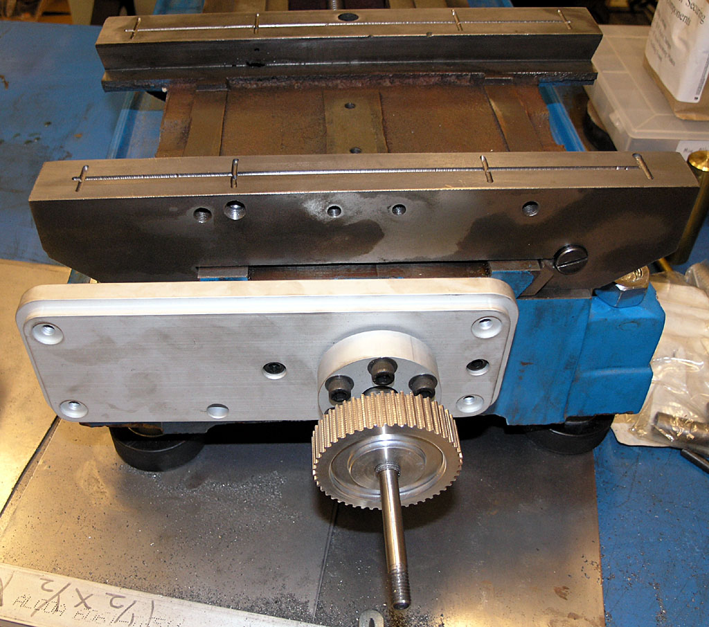 Metalworking machine with blue base and gear components.