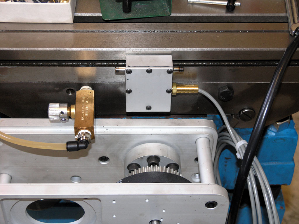 Machinery components, gears, wires, and mechanical parts in a workshop or factory setting.