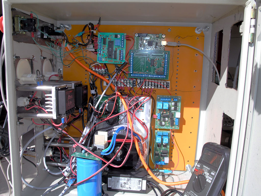 Electrical cabinet with complex wire arrangement and circuit boards.