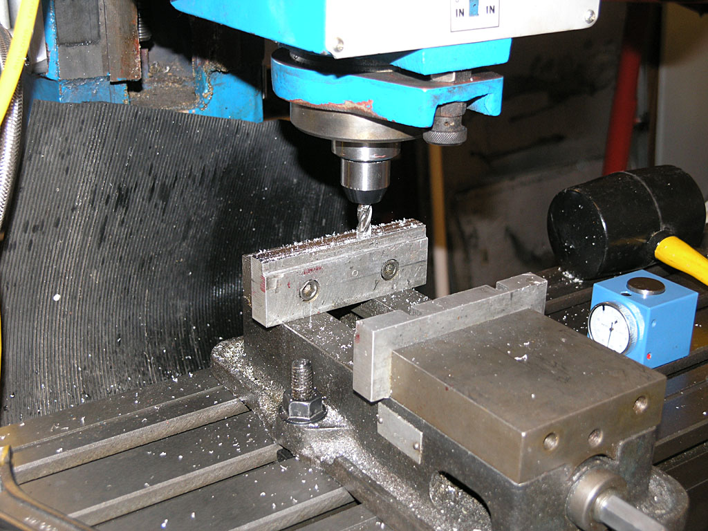Milling machine on a black background with metalwork and CNC equipment.