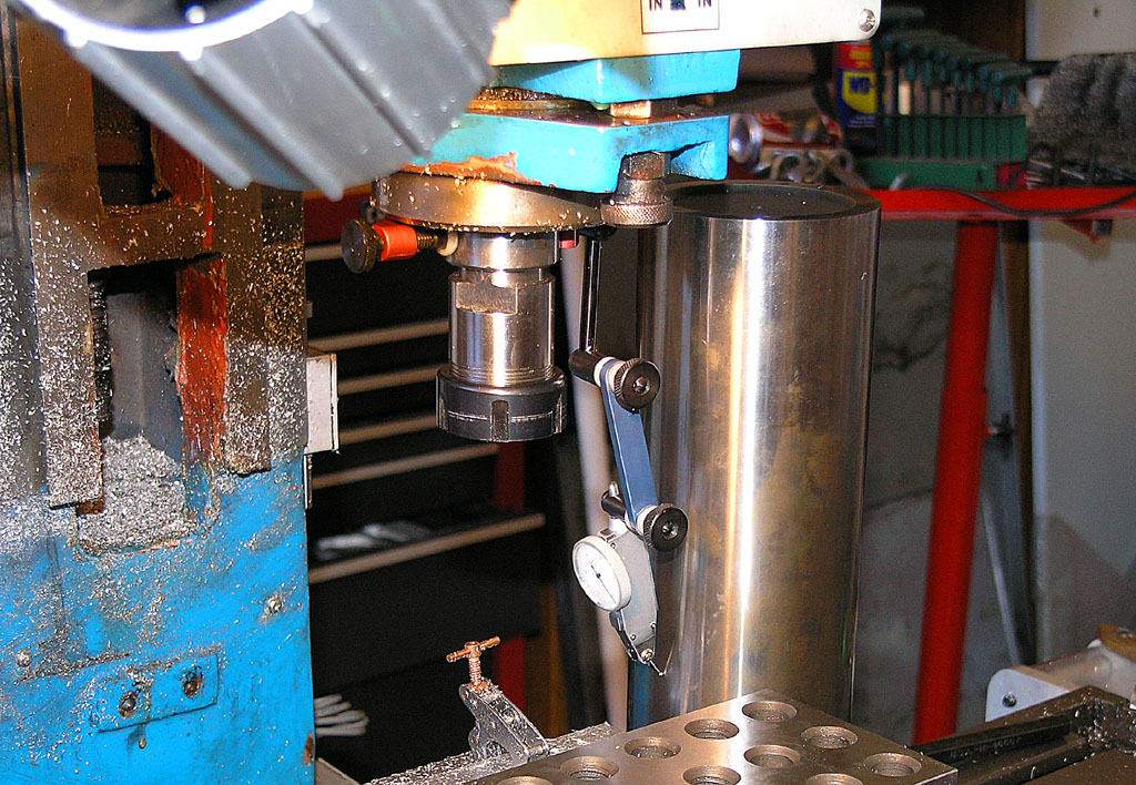 Stainless steel drilling machine with blue and yellow top section and white dial.