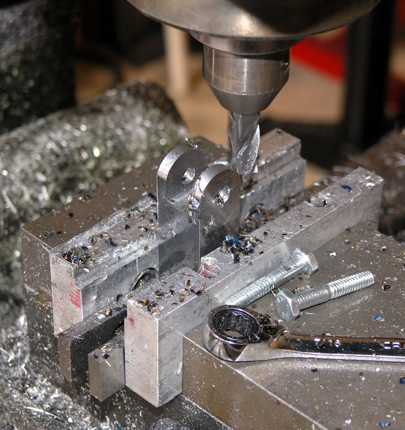 Metalworking machine tool in operation with drill bit and vise.