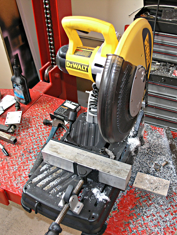 A DeWalt circular saw on a red workbench with metal shavings and tooling nearby.