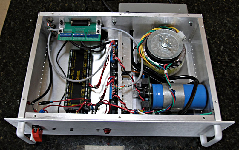 Silver colored metal box interior with wires, circuit board, and electronic parts.