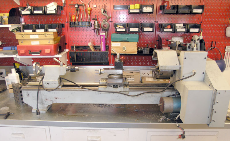 Well-organized metalworking workshop with lathe and tools.