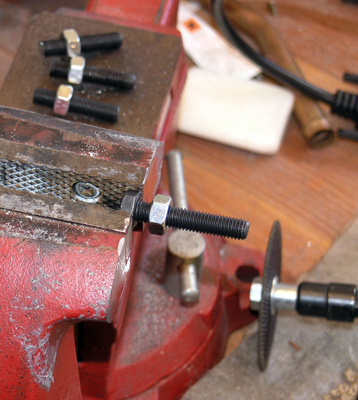 Red metal vise with weathered appearance.