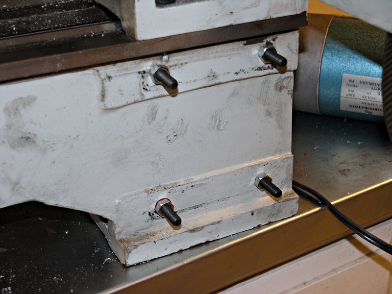 Metalworking lathe in a workshop setting, featuring detailed machinery and equipment.