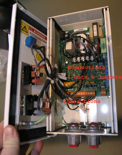Open electrical panel with components, wires, and circuit boards visible.