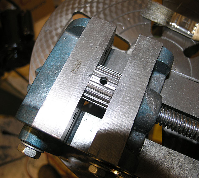 Metal object with rectangular shape and two parallel bars, featuring "CHINA" engraving in metallic surface.