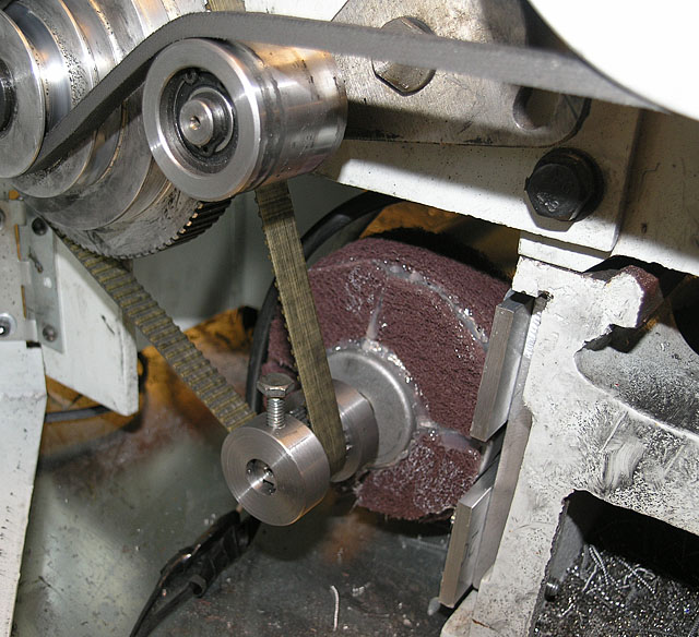 Metalworking machine internal mechanism with gears, belts, and pulleys.