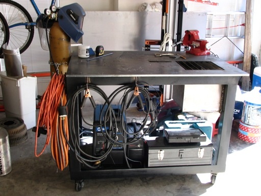 Plasma cutting table with tools and equipment.