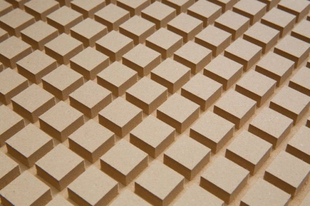 A close-up photograph of a plenum board with rectangular tan blocks in a grid pattern.