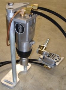 Silver metal tool with black hose, handle, and lever.