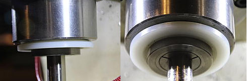 A close-up of a cylindrical metal slinger with a smooth surface and no markings.