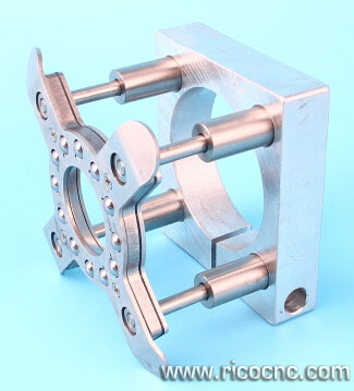 Metal spindle foot with square base and four cylindrical rods on a light blue background.
