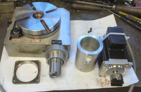 Metal parts and tools on a workbench.