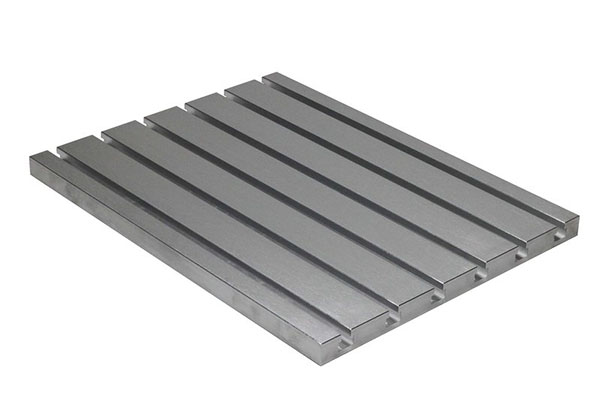 Angular view of a rectangular aluminum T-slot plate with 6 evenly spaced grooves.