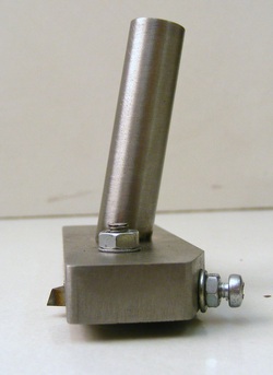 Silver metal component with cylindrical protrusion and securing nut.