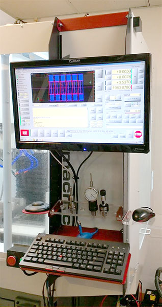 Computer monitor displaying a grid pattern with blue and red squares.