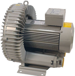 Gray vacuum pump with yellow accents, cylindrical shape, and horizontal ridges.