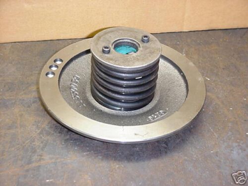 Dark gray metal pulley with three holes, worn steel or aluminum drive wheel.